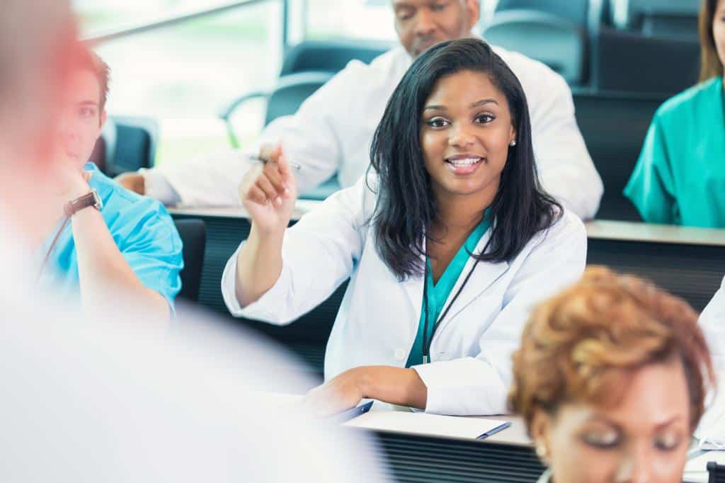 medical sciences student asking question in at a healthcare conference